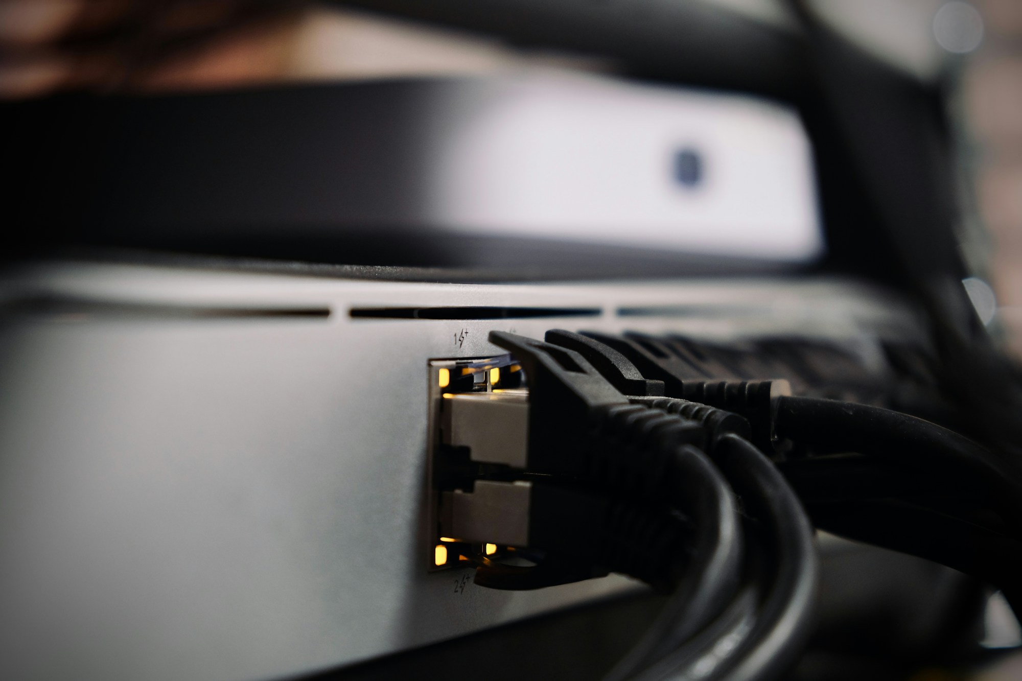 Nahaufnahme angeschlossener Netzwerkkabel an einem Netzwerkgerät